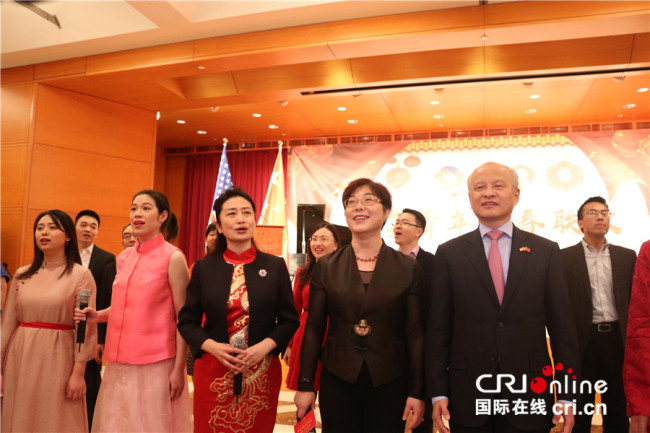 Chinese Ambassador Cui Tiankai (1st right, front), joins in the chorus of the song "My motherland and I" in the hall of the Chinese embassy in Washington on Saturday, February 16, 2019. [Photo: China Plus/Liu Kun]
