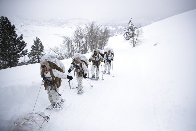 A group of U.S. Marines walk along a snow-covered trail during their advanced cold-weather training at the Marine Corps Mountain Warfare Training Center Sunday, Feb. 10, 2019, in Bridgeport, Calif. After 17 years of war against Taliban and al-Qaida-linked insurgents, the military is shifting its focus to better prepare for great-power competition with Russia and China, and against unpredictable foes such as North Korea and Iran. [Photo: AP]