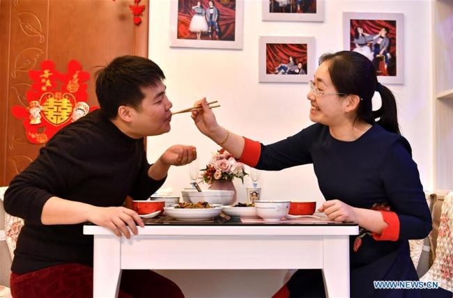 Ma Jinzhao (L) and Zhang Wenye eat at home in Taiyuan, north China's Shanxi Province, Feb. 13, 2019. [Photo: Xinhua]