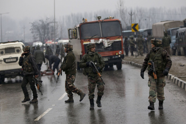 Indian paramilitary soldiers patrol at the site of an explosion in Pampore, Indian-controlled Kashmir, Thursday, Feb. 14, 2019. [Photo: AP/Dar Yasin]