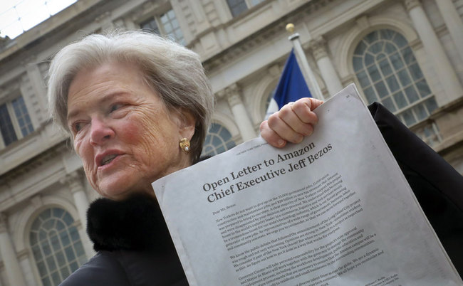 Kathryn Wilde, Partnership for New York City president and CEO, poses outside City Hall holding a letter to Amazon published in the New York Times, Friday March 1, 2019, in New York. Wilde joined a coalition of business, government, community and labor interests calling on Amazon's CEO Jeff Bezos to reconsider building a campus in New York. [Photo: AP/Bebeto Matthews]