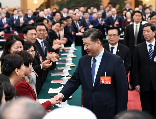 President Xi Jinping shakes hands with a deputy from Henan Province at the second session of the 13th National People's Congress in Beijing, March 8, 2019. [Photo: Xinhua]