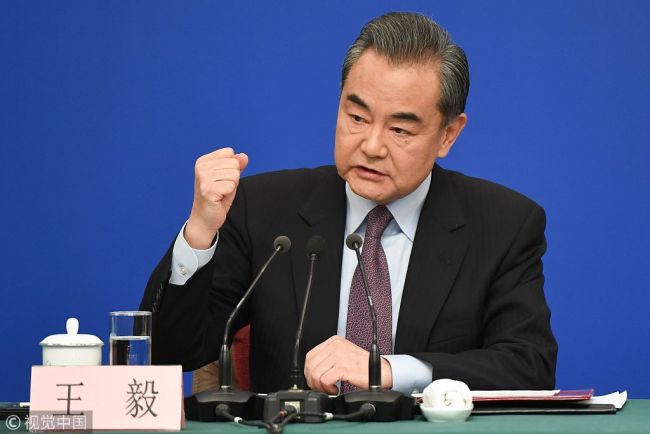 China's Foreign Minister Wang Yi answers questions during a press conference on the sidelines of the National People's Congress in Beijing on Friday, March 8, 2019. [Photo: VCG]