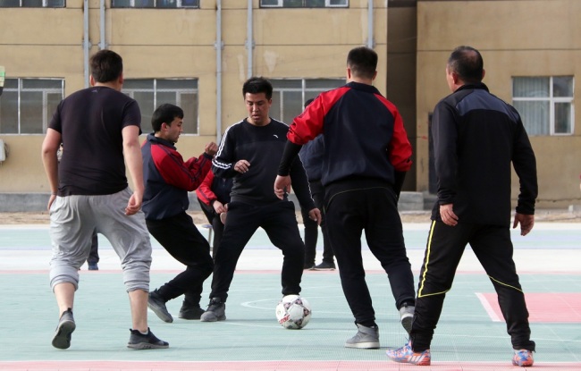 Students are playing soccer at the Xinjiang Kashgar Vocational Education and Training Center. [Photo: China Plus/ Du Junshuai]