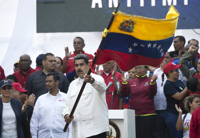 Venezuela's President Nicolas Maduro waves a national flag during a pro-government rally in Caracas, Venezuela, Saturday, March 9, 2019. [Photo: AP/Ariana Cubillos]