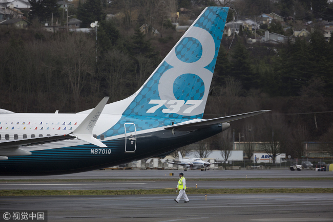 Crewman tow in a Boeing Co. Max 737 jet after landing at King County International Airport in Seattle, Washington, U.S., on Friday, Jan. 29, 2016. [Photo: VCG]