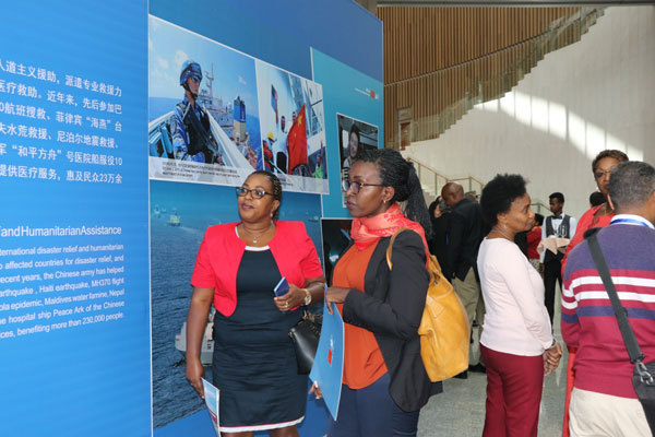 People visit an exhibition "Chinese People's Liberation Army: A Force for World Peace," which  showcases the Chinese military's practices and achievements in safeguarding the world peace and advancing common development, in Addis Ababa, Ethiopia, on March 18, 2019. [Photo: China Plus]