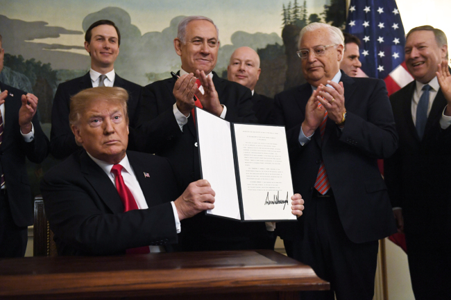 U.S. President Donald Trump holds up a signed proclamation recognizing Israel's sovereignty over the Golan Heights, as Israeli Prime Minister Benjamin Netanyahu looks on in the Diplomatic Reception Room of the White House in Washington, Monday, March 25, 2019. [Photo: AP/Susan Walsh]