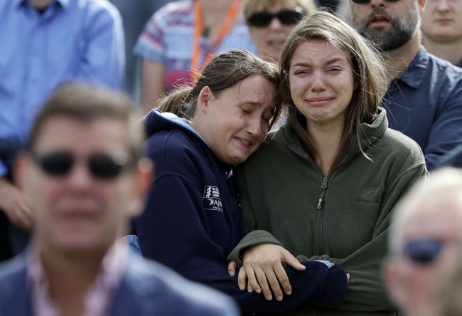 Women react as the New Zealand national anthem is sung during a national remembrance service in Hagley Park for the victims of the March 15 mosque terrorist attack in Christchurch, New Zealand, Friday, March 29, 2019. [Photo: AP/Mark Baker]