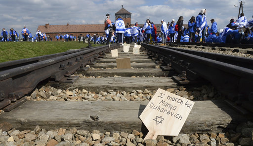 Participants of the yearly March of the Living place memory plaques on the rails in the former German Nazi Death Camp Auschwitz-Birkenau, in Brzezinka, Poland, Monday, April 24, 2017. [Photo: AP]