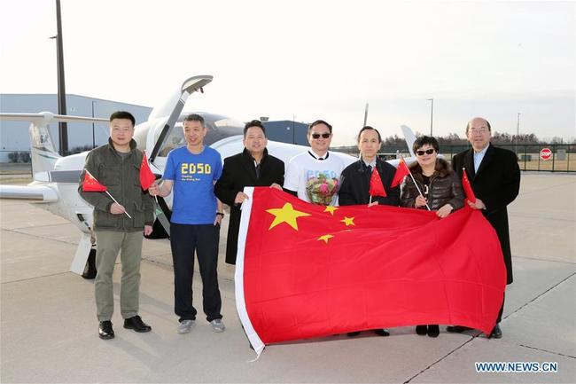 Zhang Bo (C) poses for photos in front of his aircraft at an airport in Chicago, the United States, on April 2, 2019. The 57-year-old Chinese man Zhang Bo kicked off his second flight around the world on Tuesday in a Diamond DA42 aircraft from Chicago. [Photo: Xinhua]