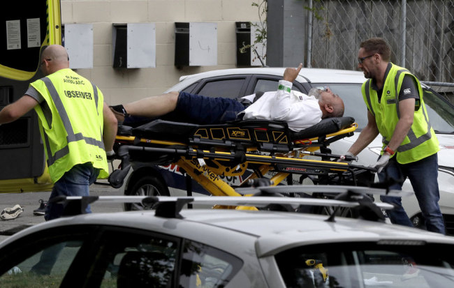 In this March 15, 2019, file photo, ambulance staff take a man from outside a mosque in central Christchurch, New Zealand. [File photo: AP/Mark Baker]