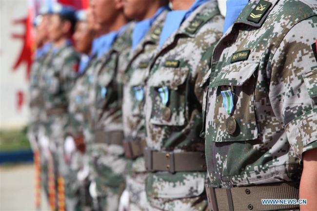 Chinese peacekeepers wearing the United Nations Peace Medal of Honor are seen at the awarding ceremony at the camp of the Chinese peacekeeping multi-functional engineer detachment to Lebanon in Hanniyah village in southern Lebanon, on April 6, 2018. [File photo: Xinhua]
