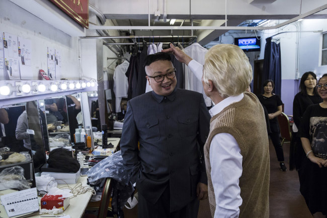 Chan Hung-chun (C), dressed as North Korean Leader Kim Jong-un, reacts with follow actors back stage during a rehearsal of a Cantonese opera called "Trump on Show", in Hong Kong on April 11, 2019. [Photo:AFP]