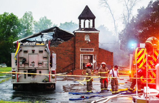 In this April 4, 2019 file photo, firefighters and fire investigators respond to a fire at Mt. Pleasant Baptist Church, in Opelousas, La. Authorities have arrested a person in connection with suspicious fires at three historic black churches in southern Louisiana, a federal prosecutor said. The suspect was in state custody, U.S. Attorney David C. Joseph announced late Wednesday, April 10 in a news release labeling the fires "despicable acts."[Photo: AP]