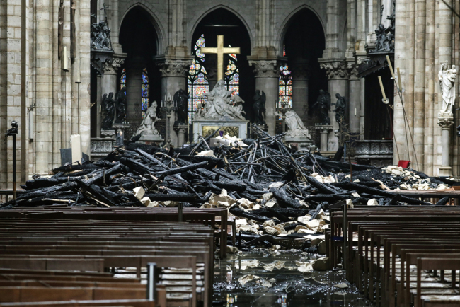 A picture taken on April 16, 2019 shows the altar surrounded by charred debris inside the Notre-Dame Cathedral in Paris in the aftermath of a fire that devastated the cathedral. [Photo: AFP]