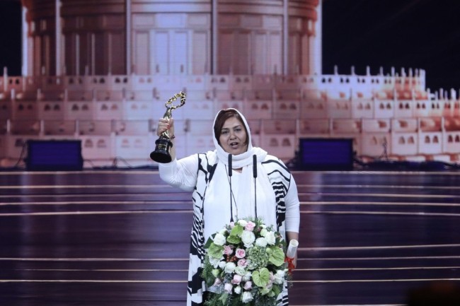 Forough Ghajabagli raises the trophy after winning the Best Actress award for her role in "Tehran: City of Love" at the closing ceremony for the 9th Beijing International Film Festival, on April 20, 2019, in Beijing. [Photo: IC]