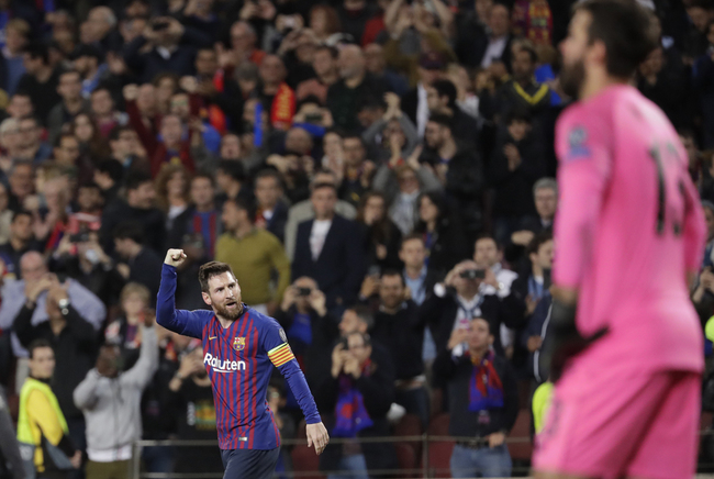 Barcelona's Lionel Messi celebrates after scoring his side's second goal as Liverpool goalkeeper Alisson gestures during the Champions League semifinal, first leg, soccer match between FC Barcelona and Liverpool at the Camp Nou stadium in Barcelona, Spain, Wednesday, May 1, 2019. [Photo: AP/Emilio Morenatti]