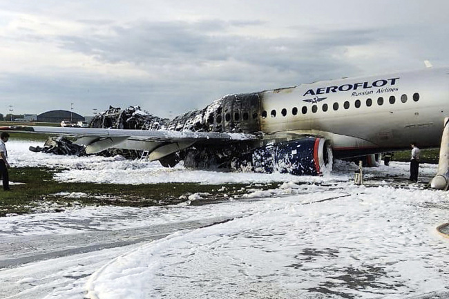 The Sukhoi Superjet 100 aircraft of Aeroflot Airlines is covered in fire retardant foam after an emergency landing in Sheremetyevo airport in Moscow, Russia, Sunday, May 5, 2019. [Photo: AP]