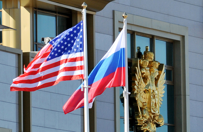 The United States and Russia national flags run up. [File photo: AP]