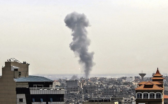 Smoke billows above buildings in Rafah in the southern Gaza Strip during an Israeli airstrike on the Palestinian coastal enclave, on May 5, 2019. [Photo: AFP/Said Khatib]  