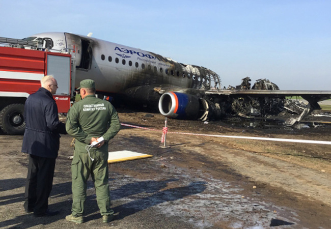 This handout picture taken and realeased on May 6, 2019 shows a head of Russian Investigative Committee Alexander Bastrykin (L) as he speaks with unidentified investigator at a site of a fire of a Russian-made Superjet-100 at Sheremetyevo airport outside Moscow. [Photo: AFP]