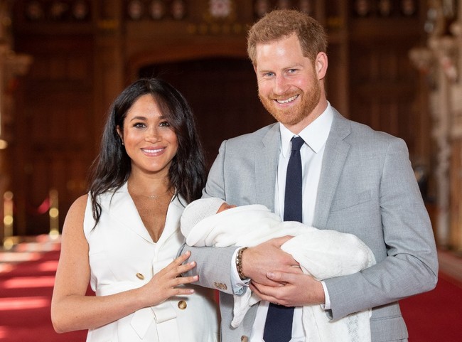 Britain's Prince Harry, Duke of Sussex, and his wife Meghan, Duchess of Sussex, pose for a photo with their newborn baby son in St George's Hall at Windsor Castle in Windsor, west of London on May 8, 2019. [Photo: AFP/Dominic Lipinski]