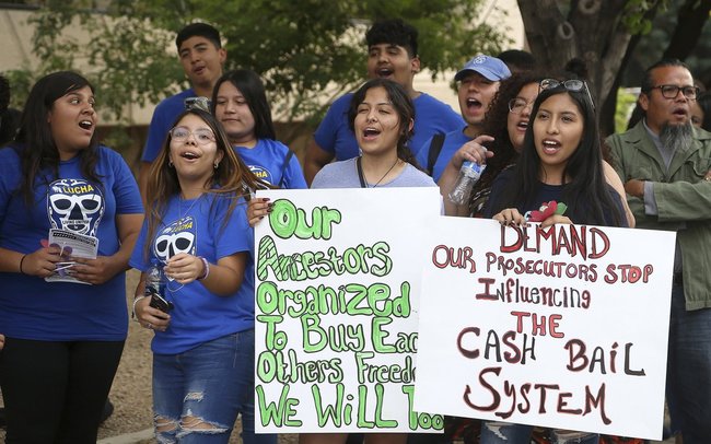 Protesters gather in front of Maricopa County Attorney Bill Montgomery's office Thursday, May 9, 2019, in Phoenix. For Mother's Day, dozens of mothers are getting time with their children instead of time behind bars as the National Bail Out Collective is organizing its "Black Mama's Bail Out" initiative to post bail for women of color who would otherwise be in jail. [Photo: AP] 