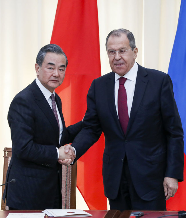 Chinese State Councilor and Foreign Minister Wang Yi (L) shakes hands with Russian Foreign Minister Sergei Lavrov at the end of a joint press conference following their meeting in Sochi on May 13, 2019. [Photo: Pool/AFP/Pavel Golovkin]