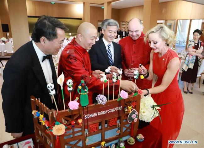 A Chinese chef (2nd L) shows the dough figurines he made at "Confucius Institute Banquet -- A Taste of Sichuan" in Dublin, Ireland, May 15, 2019. [Photo: Xinhua/Liu Xiaoming]