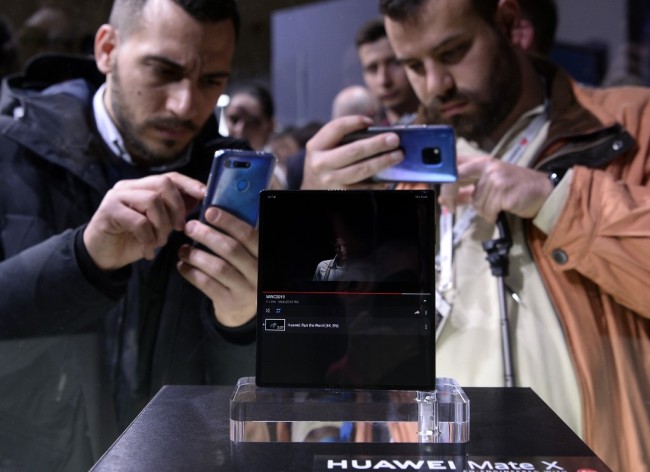 Visitors take images of Huawei's new foldable 5G smartphone HUAWEI Mate X at the Mobile World Congress (MWC), on February 24, 2019 in Barcelona.[Photo: AFP]