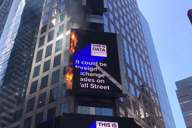 In this image from video provided by WABC TV, flames shoot from the digital billboard at 3 Times Square in New York City, Saturday, May 18, 2019. The Fire Department says no injuries have been reported and there was no damage to the building the sign is attached to. [Photo: WABC TV via AP]