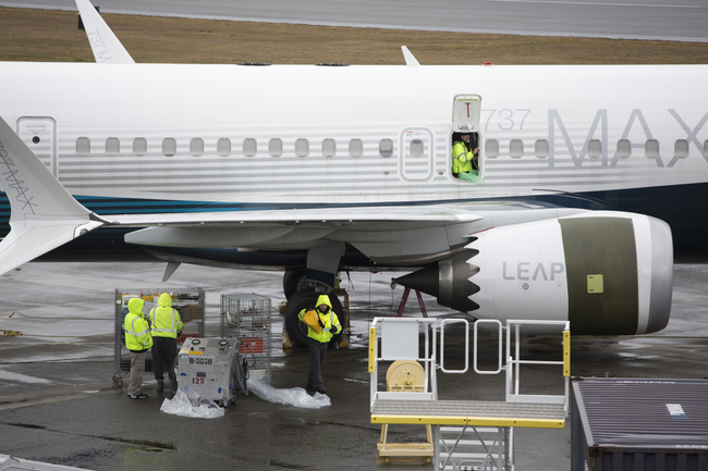 In this file photo taken on March 12, 2019, workers are pictured next to a Boeing 737 MAX 9 airplane on the tarmac at the Boeing Renton Factory in Renton, Washington, U.S. [Photo: AFP]