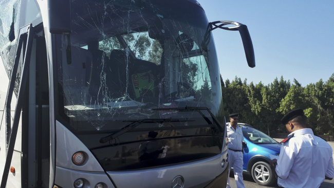 A picture taken on May 19, 2019, shows a bus damaged during a bomb blast near Egypt's famed Giza pyramids. [Photo: AFP]