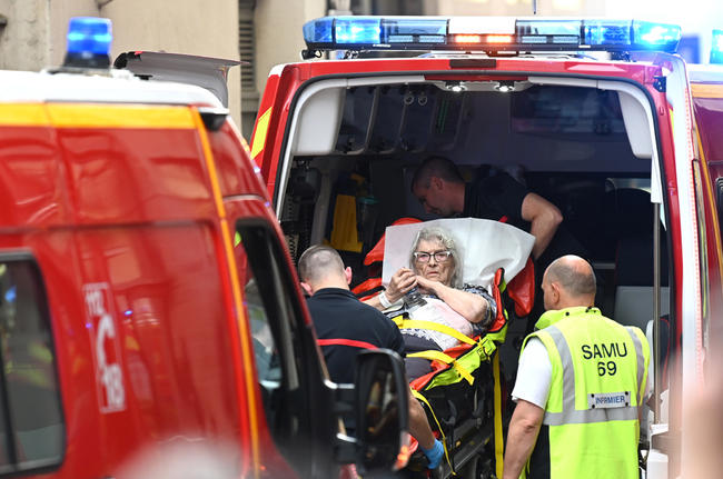 Emergency workers stretcher a woman to a waiting ambulance after a suspected package bomb blast along a pedestrian street in the heart of Lyon, southeast France, the local prosecutors' office said on May 24, 2019. [Photo: AFP]