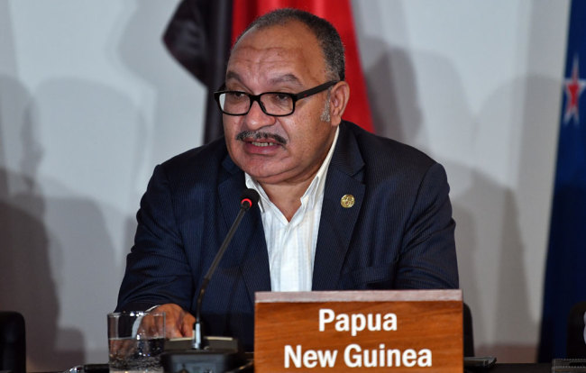 In this file photo taken on November 18, 2018 Papua New Guinea's Prime Minister Peter O'Neill speaks at an electricity projects signing ceremony during the Asia-Pacific Economic Cooperation (APEC) Summit in Port Moresby. O'Neill resigned on May 26, 2019. [Photo: AFP/Saeed Khan]