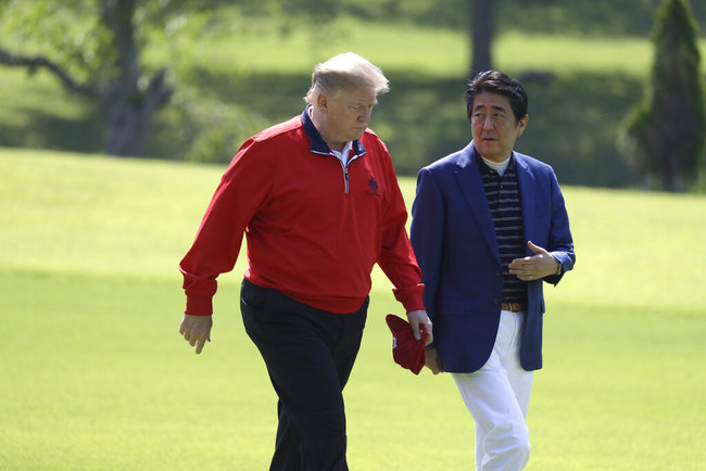 President Donald Trump walks with Japanese Prime Minister Shinzo Abe before playing a round of golf at Mobara Country Club, Sunday, May 26, 2019, in Chiba, Japan. [Photo: AP]