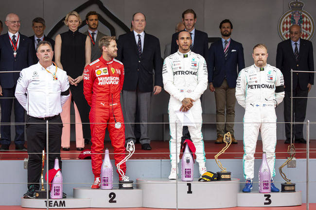 Lewis Hamilton, Sebastian Vettel, Valterri Bottas, Prince Albert II, Princess Charlene, Andrea Casiraghi, Pierre Casiraghi, Louis Ducruet pose on the podium at the 77th Monaco Grand Prix, Monaco on May 26th, 2019. [Photo: IC]