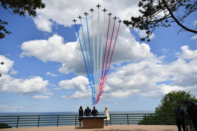 (From L) US First Lady Melania Trump, US President Donald Trump, French President Emmanuel Macron and French President's wife Brigitte Macron watch as French elite acrobatic flying team "Patrouille de France" (PAF) fly over after a French-US ceremony at the Normandy American Cemetery and Memorial in Colleville-sur-Mer, Normandy, northwestern France, on June 6, 2019, as part of D-Day commemorations marking the 75th anniversary of the World War II Allied landings in Normandy. [Photo: AFP/Mandel Ngan]