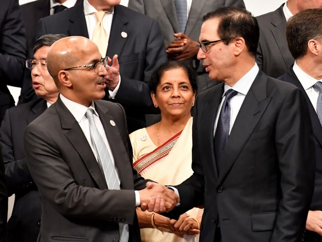 US Treasury Secretary Steven Mnuchin (R) shakes hands with Saudi Arabia's Finance Minister Mohammed Aljadaan (L) while attending a family photo session at the G20 finance ministers and central bank governors meeting in Fukuoka on June 9, 2019. [Photo: AFP]