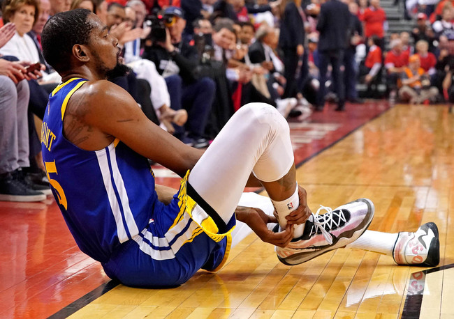 Golden State Warriors forward Kevin Durant (35) sits on the court after an injury during the second quarter in Game 5 against the Toronto Raptors of the 2019 NBA Finals in Toronto, Monday, June 10, 2019. [Photo: IC]