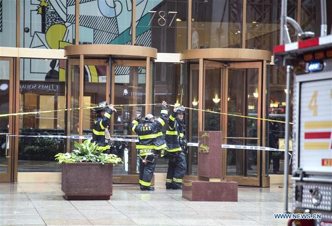 Fire fighters enter the building where a helicopter crashed in Manhattan, New York, the United States, June 10, 2019. [Photo: Xinhua]