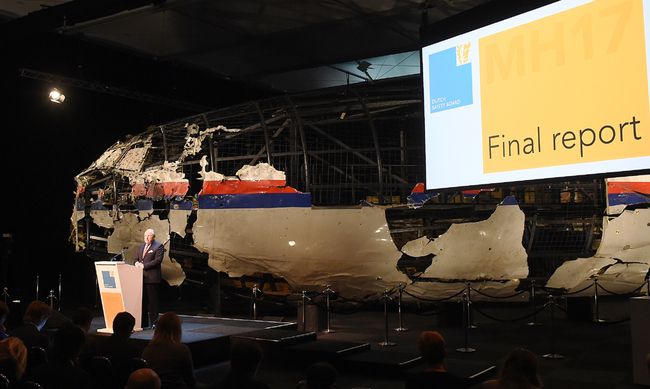 Dutch Safety Board Chairman Tjibbe Joustra speaks in front of the wrecked cockpit of the Malaysia Airlines flight MH17 exhibited during a presentation of the final report on the cause of the its crash at the Gilze Rijen airbase October 13, 2015. [Photo: AFP]