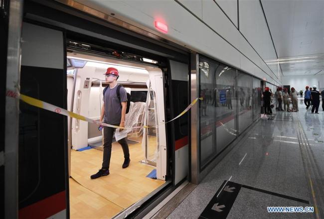 A journalist visits a train of the new airport subway line in Beijing, capital of China, June 15, 2019. [Photo: Xinhua]