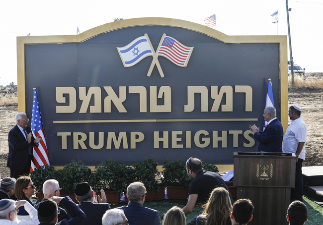 Israeli Prime Minister Benjamin Netanyahu (2nd-R) and US Ambassador to Israel David Friedman (L) applaud after unveiling the place-name sign for the new settlement of "Ramat Trump", or "Trump Heights" in English, named after the incumbent US President, during an official ceremony in the Israeli-annexed Golan Heights on June 16, 2019.[Photo: AFP/Jalaa MAREY]