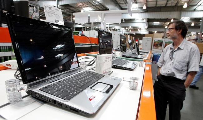 A customer looks at a display of laptop computers at a Costco warehouse store July 13, 2007 in Richmond, California. [File photo: VCG]