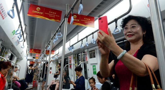 People take the first metro line of Lanzhou, Gansu, June 23, 2019. The metro line running under the Yellow River, China's second longest river, started trial operation on Sunday in Lanzhou, capital of northwest China's Gansu Province. [ Photo: IC]