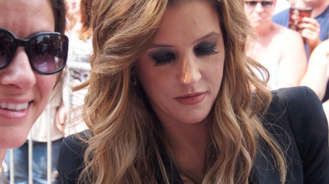 Lisa Marie Presley, daughter of rock 'n' roll icon Elvis Presley, mingles with fans and signs autographs outside her father's Graceland mansion in Memphis, Tennessee on August 17, 2012, a day after the 35th anniversary of his death. [Photo: AFP/ CAROLINE]
