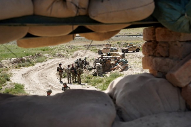 In this photo taken on June 6, 2019, US troops are seen through a firing position at the Afghan National Army (ANA) checkpoint in Nerkh district of Wardak province west of Kabul. [Photo: AFP]