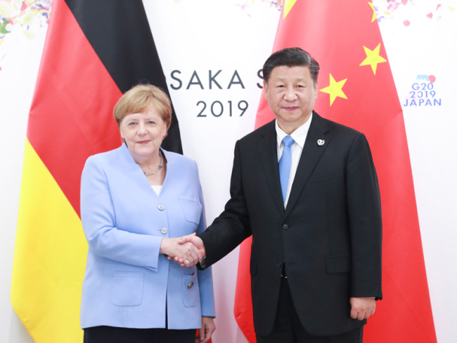Chinese President Xi Jinping (R) meets with German Chancellor Angela Merkel on the sidelines of a summit of the Group of 20 major economies in Osaka, Japan on Friday, June 28, 2019. [Photo: Xinhua]